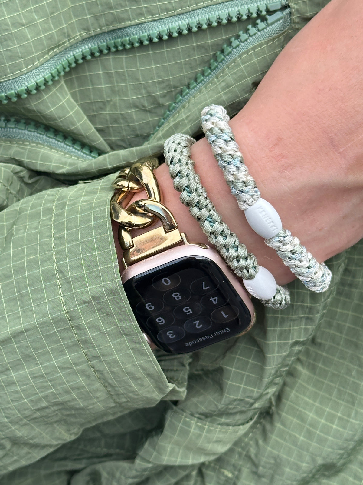 Dusty Lina Green hair elastic on woman's wrist near a watch and another KKNEKKI