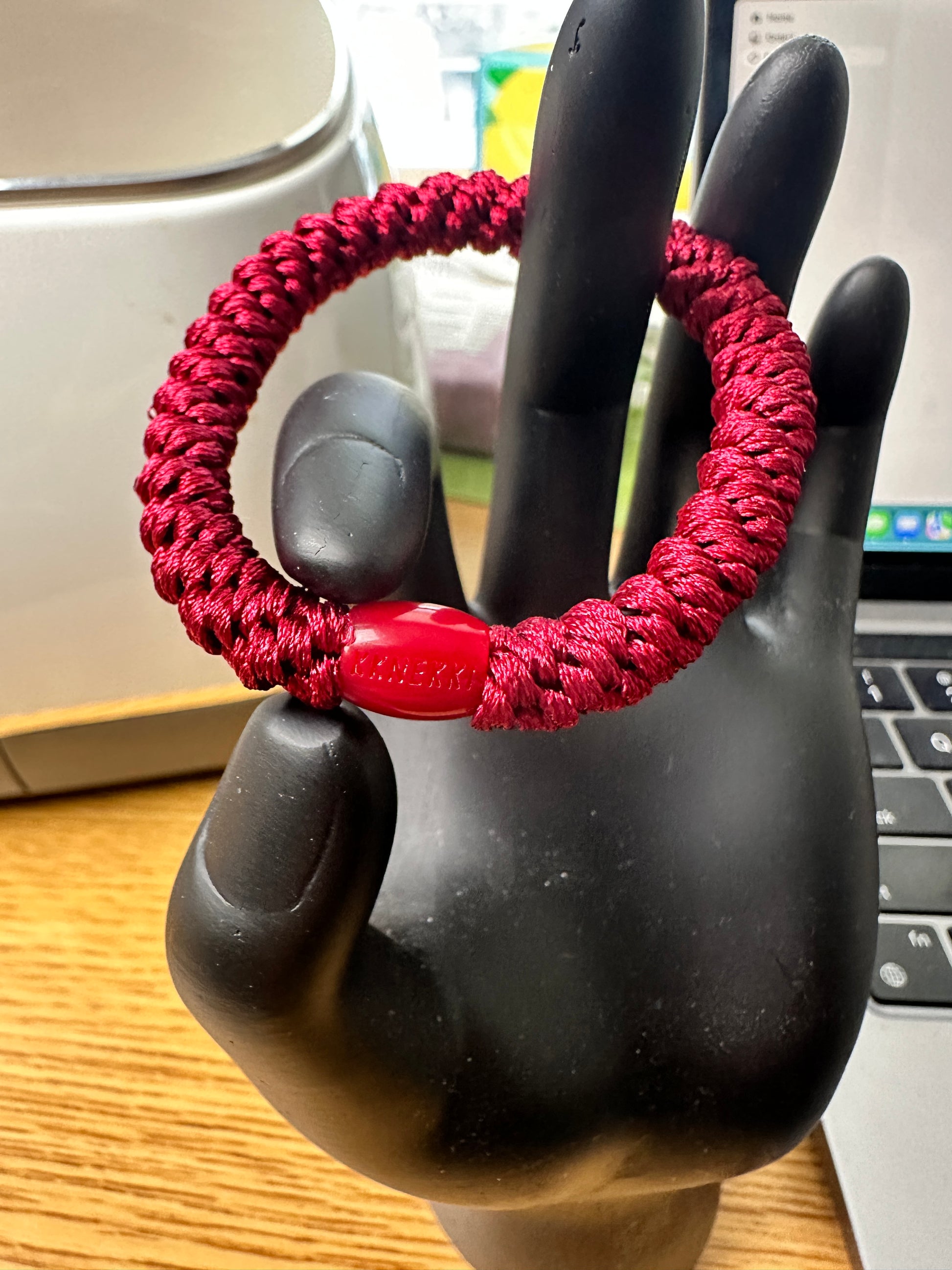 KKNEKKI Burgundy hair tie elastic on a hand model