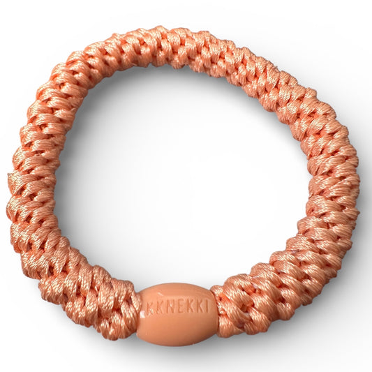 KKNEKKI Coral hair tie elastic on white background showing branded bead