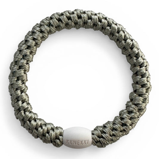 KKNEKKI Dusty Lind Green hair elastic from overhead on white background showing branded bead
