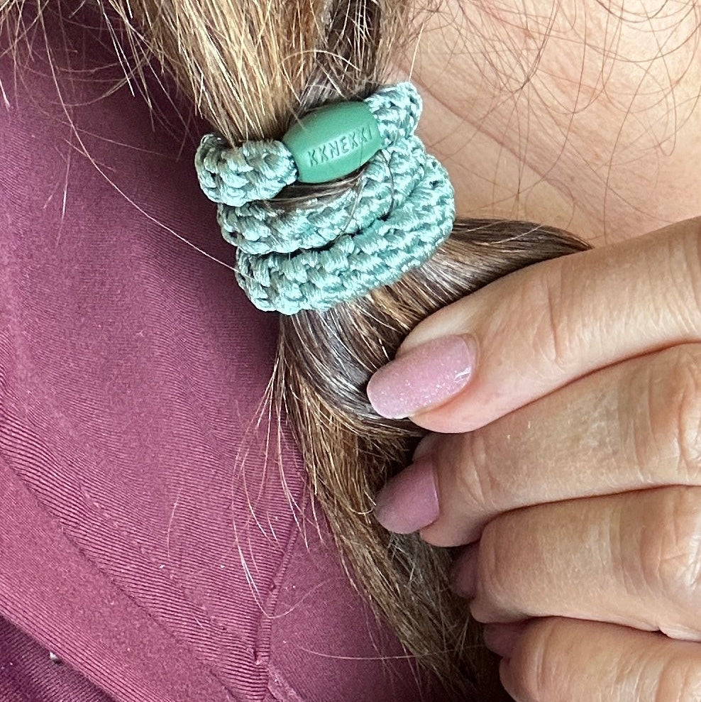 KKNEKKI Faded Green hair elastic on ponytail with woman's hand in picture