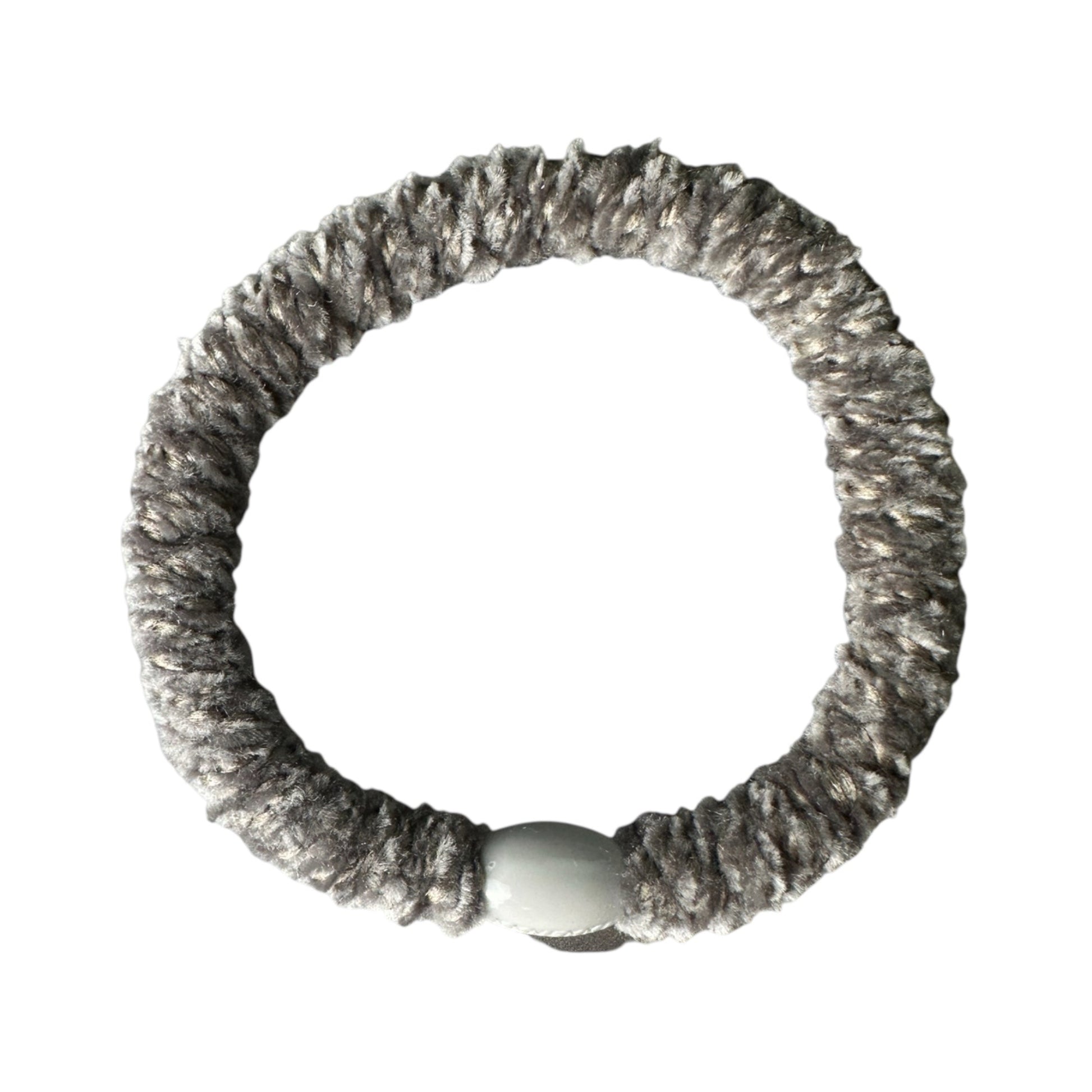 Grey KKNEKKI brand hair tie /elastic shown in original state on a white background