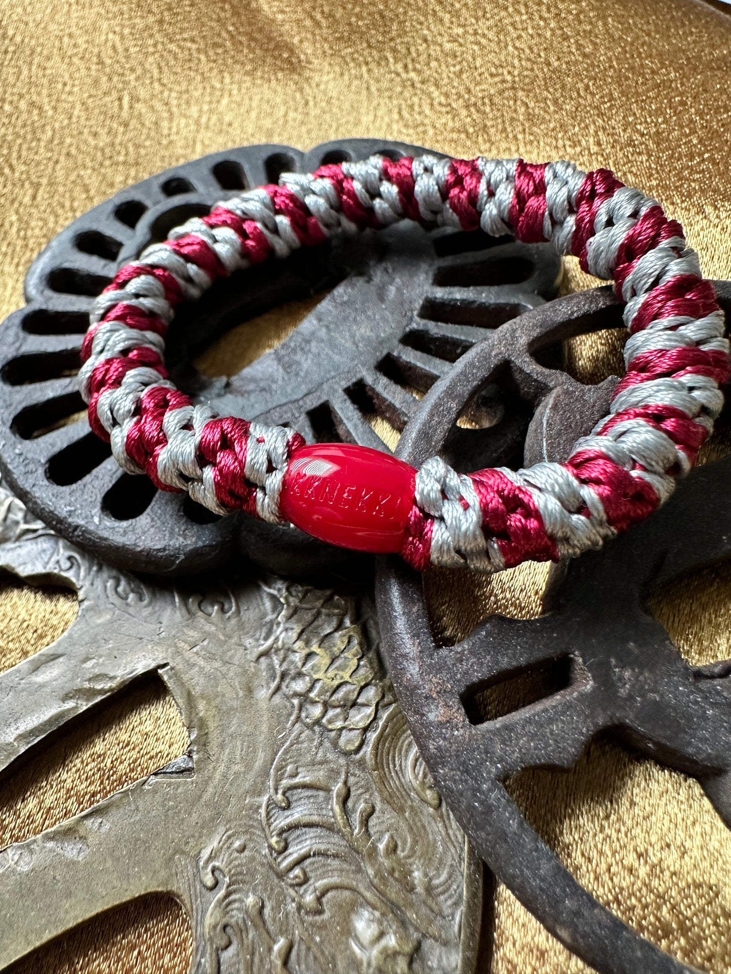 KKNEKKI Maroon-Grey hair elastic on Japanese hilts with branded bead showing
