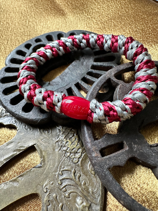 KKNEKKI Maroon-Grey hair elastic on Japanese hilts with branded bead showing
