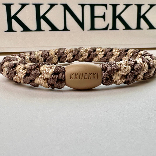 KKNEKKI Mole Beige Glitter Stripe hair elastic on white background with the KKNEKKI name behind