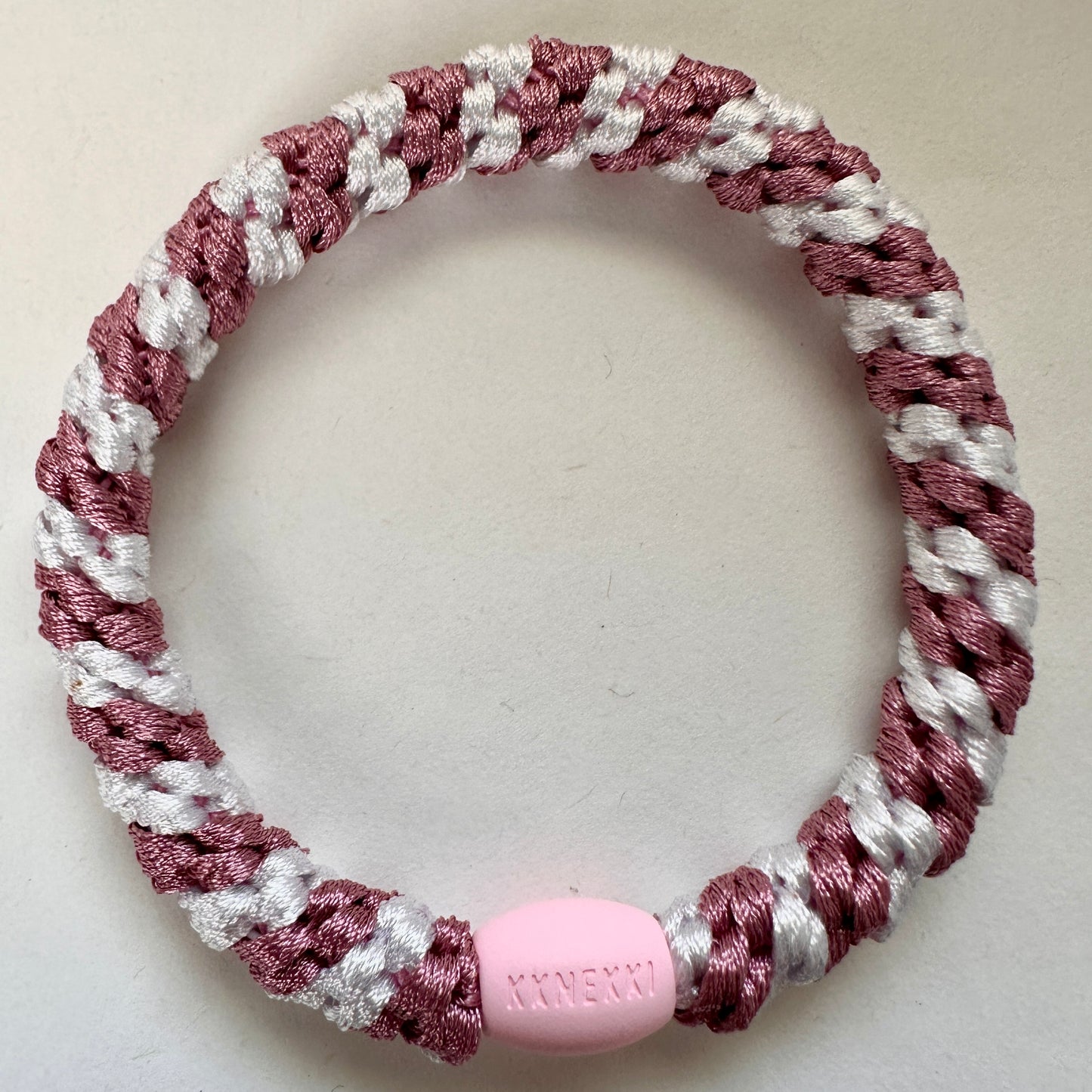 KKNEKKI Old Pink & White Stripe hair elastic laying flat on a white background 