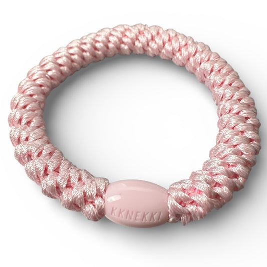 KKNEKKI Pink Light hair tie on white background shows closeup of branded bead