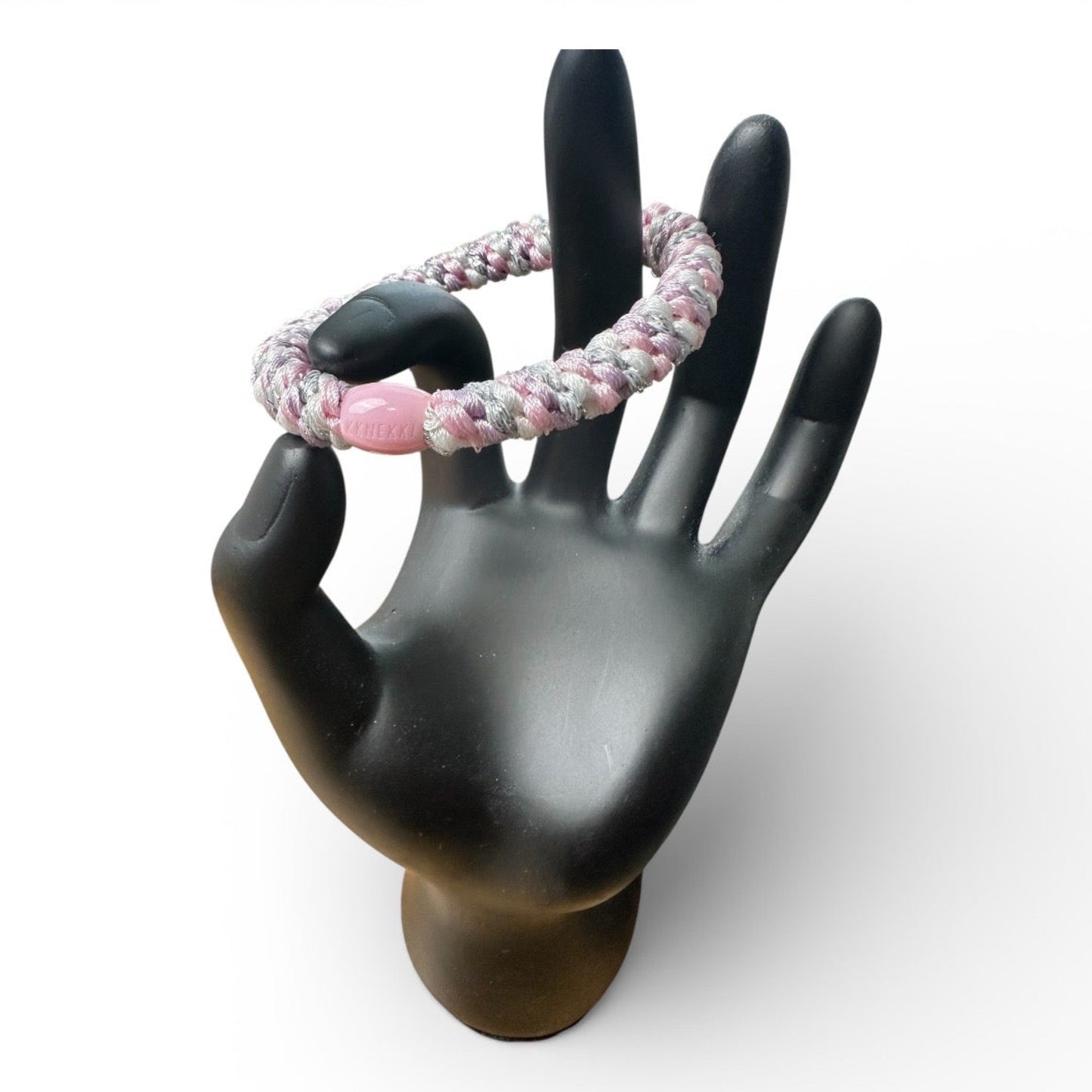 KKNEKKI Pink Sparkle Unicorn hair elastic on black hand model, branded bead clearly shown