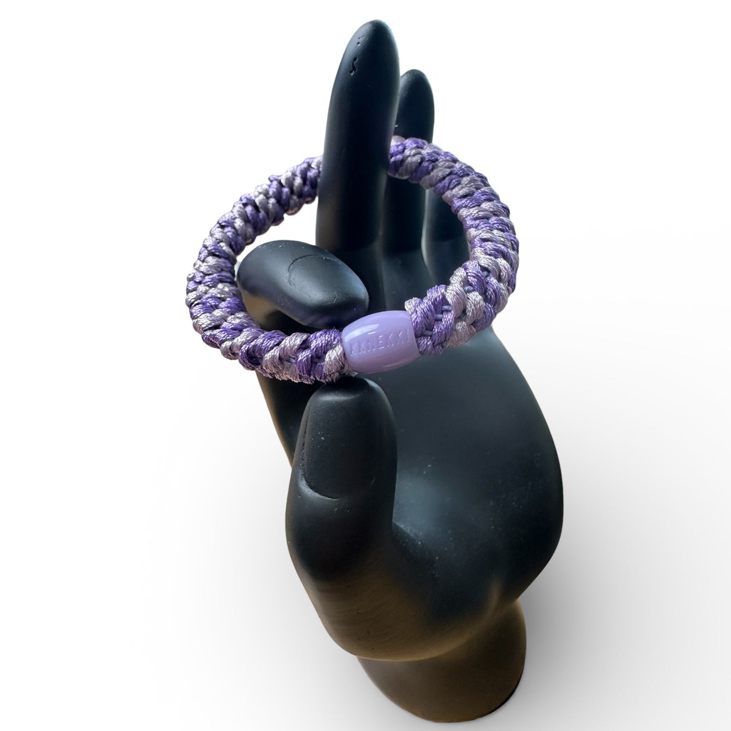 KKNEKKI Purple Light & Purple Dark Hair tie being her in black hand model clearly showing branded bead