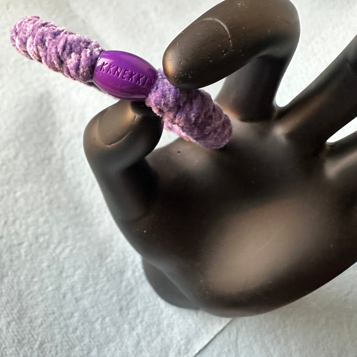 KKNEKKI Purple Velvet hair tie elastic in model hand