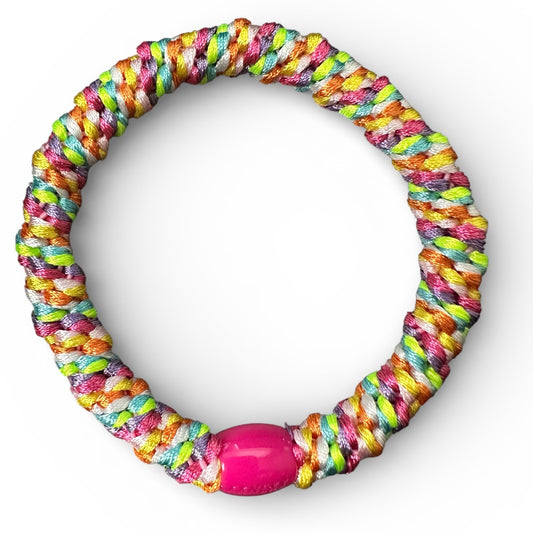 KKNEKKI Rainbow hair elastic seen from above. Pink bead with branding barely seen.