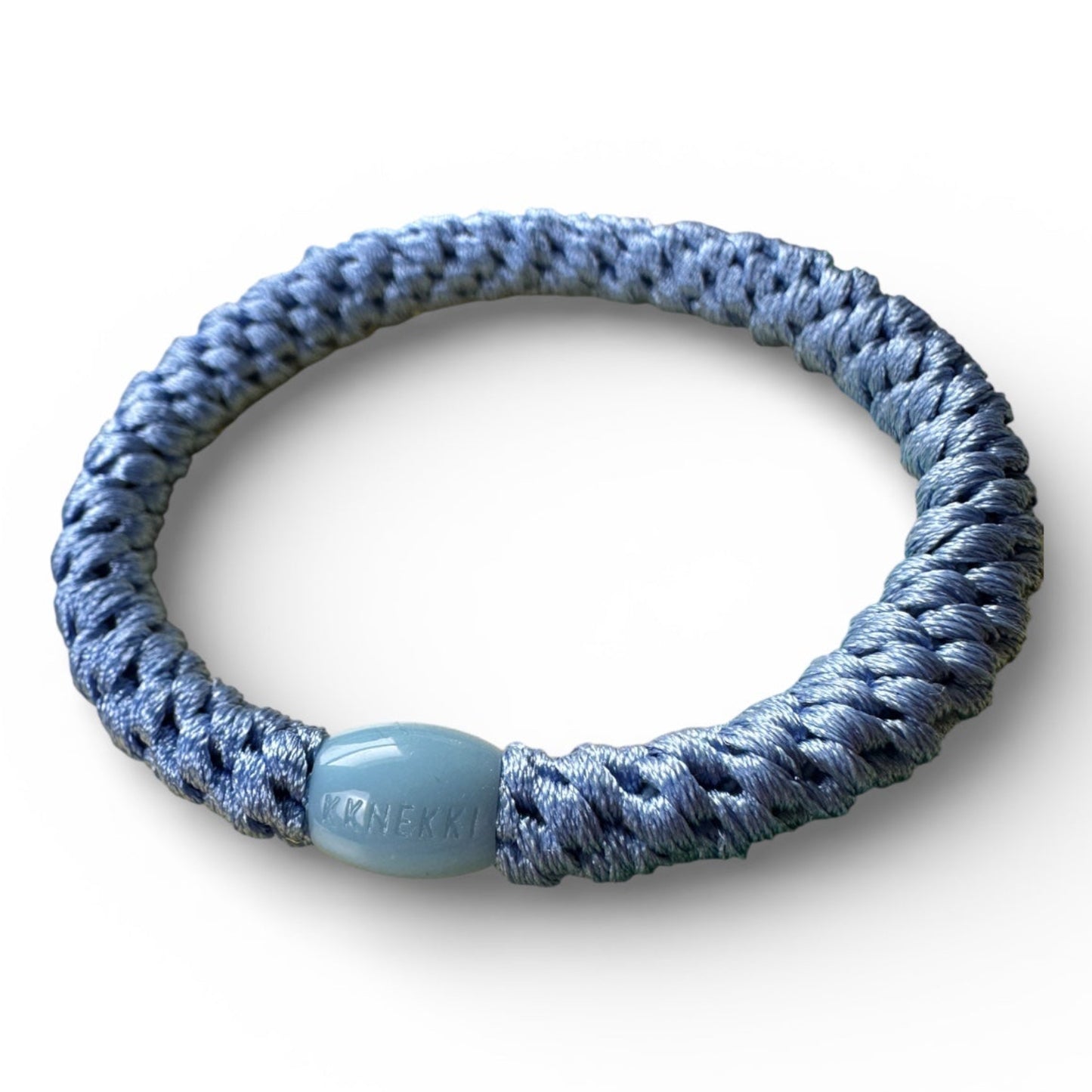 KKNEKKI Robin's Blue hair elastic slight side view to show branded bead, Sits on white background.