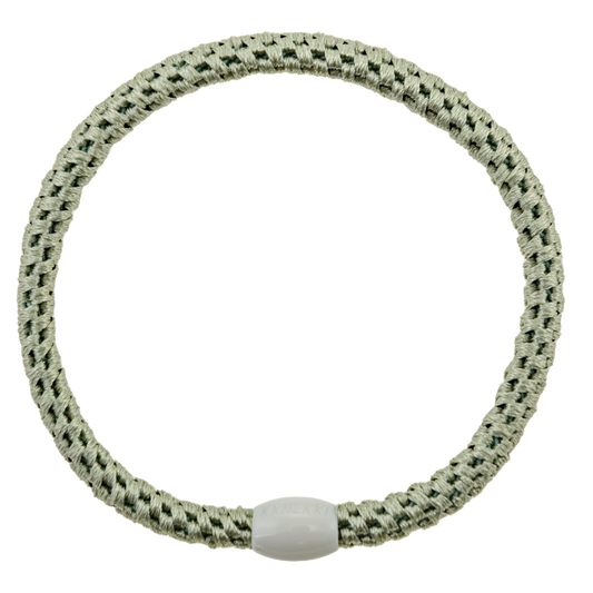 KKNEKKI Slim Dusty Lind hair elastic on white background with visible branded bead