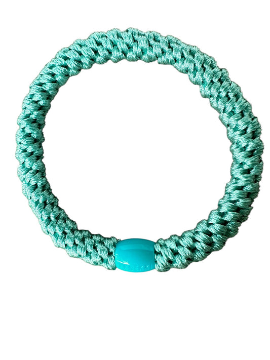 KKNEKKI Teal hair elastic on white background showing branded bead