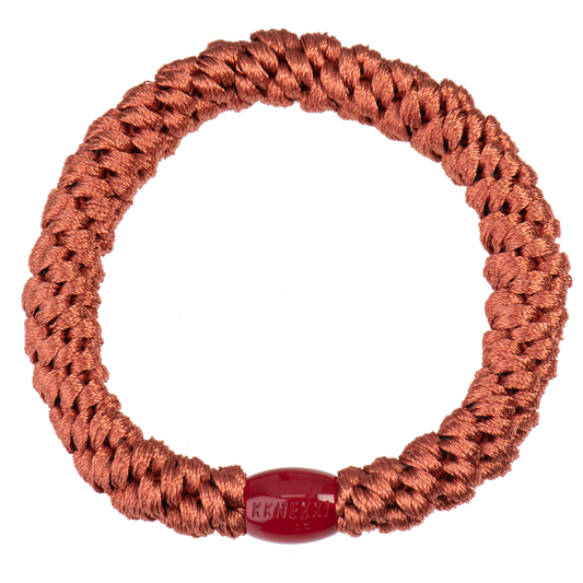 KKNEKKI Hair tie viewed from overhead with branded bead