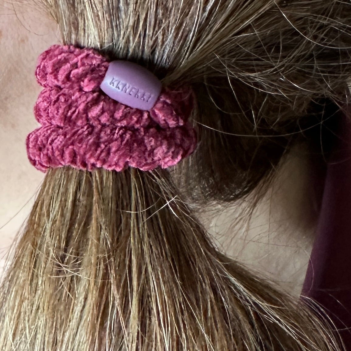 KKNEKKI  Velvet Bordeaux hair elastic on brunette hair, braided bead visible