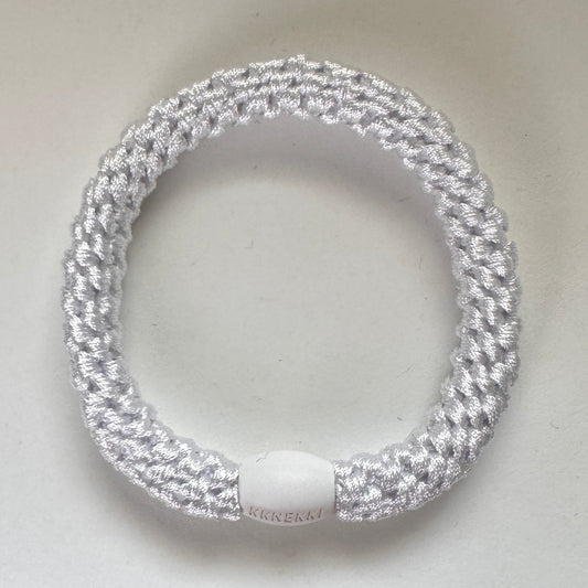 Photo showing KKNEKKI White hair tie with branded bead clearly visible